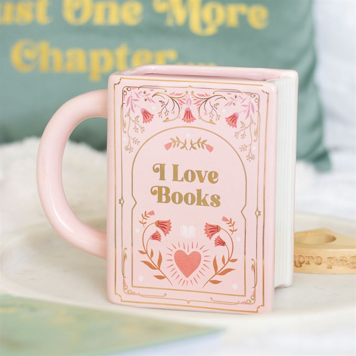 Pink mug with 'I Love Books' design on a white surface